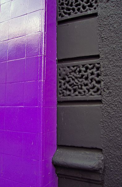 purple painted wall and decorative stone
