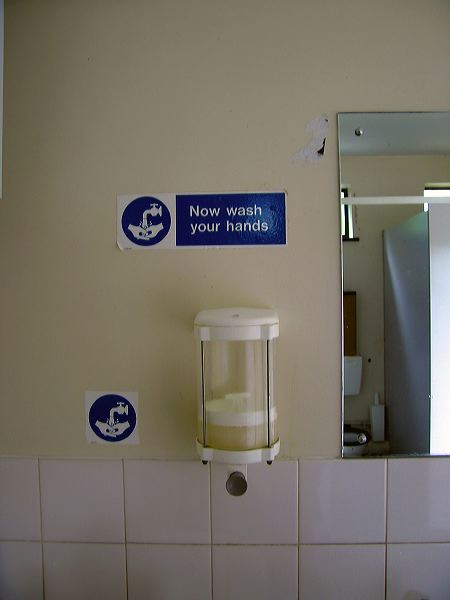 sign in a public toilet: now wash your hands